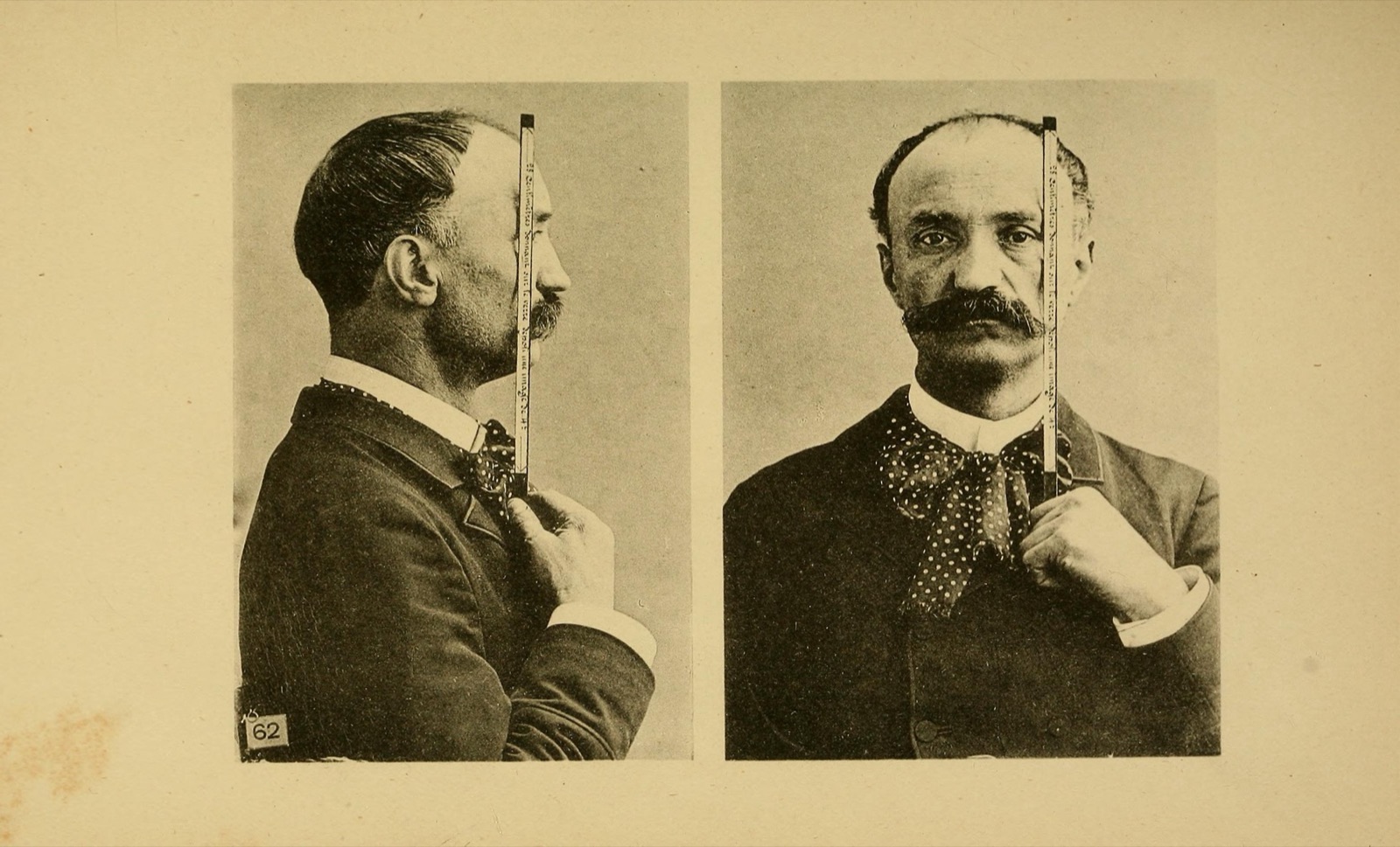 Profile and full-face portrait of a man holding a vertical rule against his face for focusing