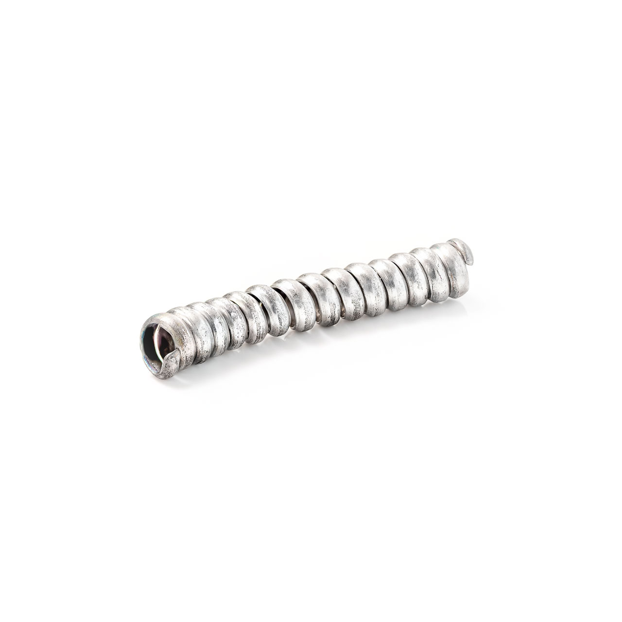 A coiled silver object on white